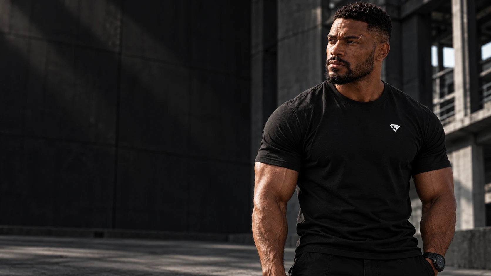 M3 wearing the black OPFIELD Field Mark Tee in a concrete industrial space